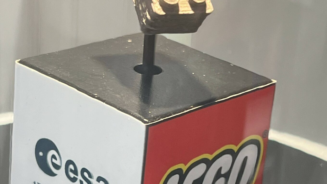 Lego space brick mounted on a display stand showing the ESA and Lego logos