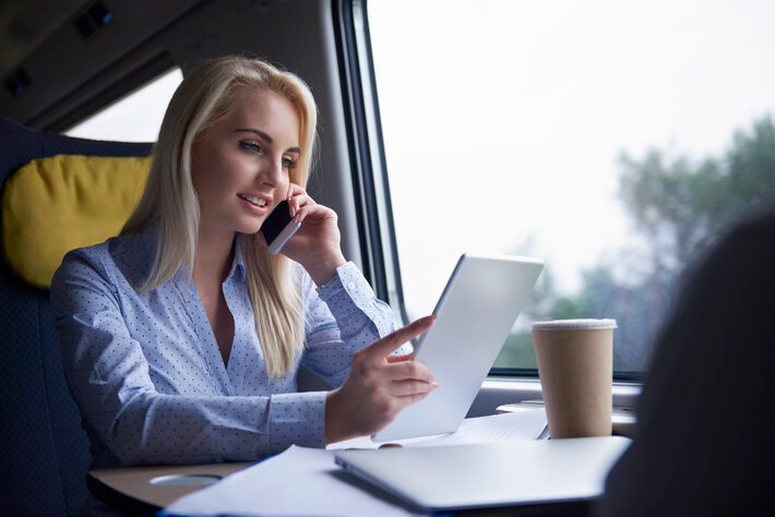 Businesswoman talking by mobile phone in the train